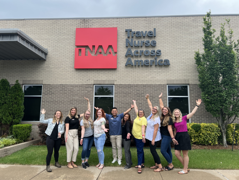 TNAA ambassadors posing in front of TNAA sign